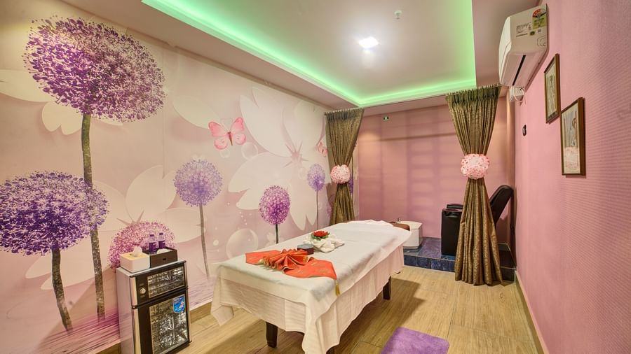 Corner view of a room featuring a spa table with pink walls in the room at Ilara Hotels & Spa, Tada.