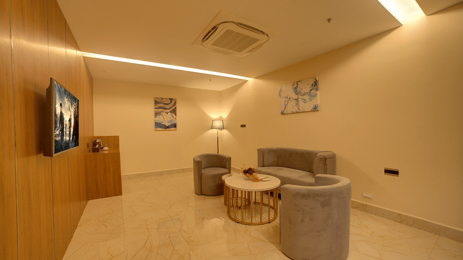 Full-view shot of the separate living area with a chic couch set along with a coffee table in front of it at Ilara Hotels & Spa, Tada.