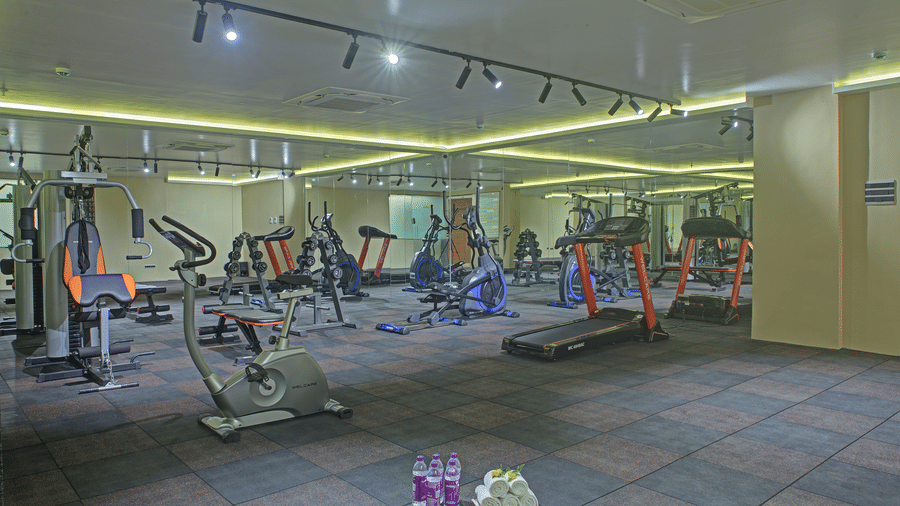 Full-view shot of a spacious gymnasium with padded flooring at Ilara Hotels & Spa, Tada.