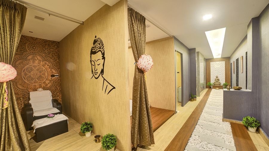 A wide-angle shot of the Hasta Spa at Ilara Hotels & Spa, Tada featuring a brightly lit corridor.