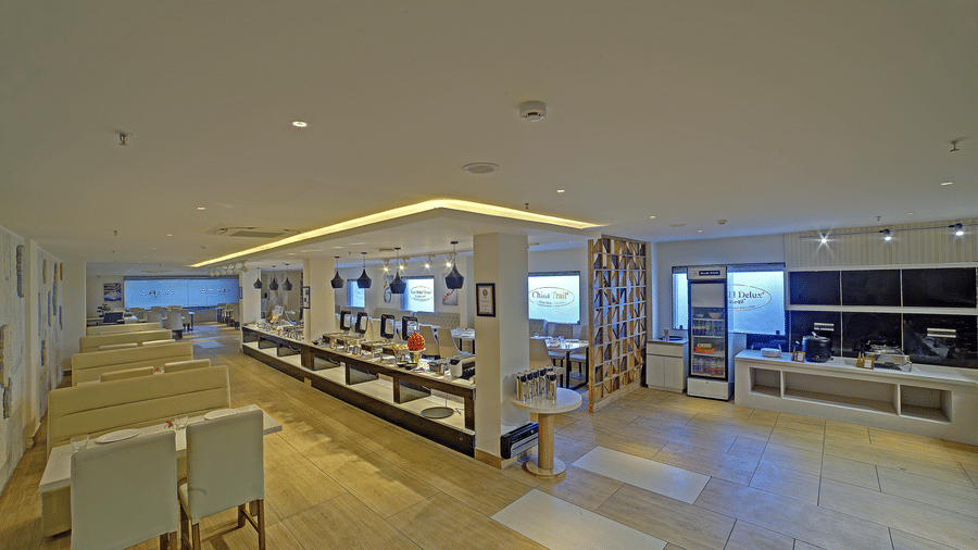 A wide-angle shot of the restaurant with the buffet counter between two pillars at Ilara Hotels & Spa, Tada.