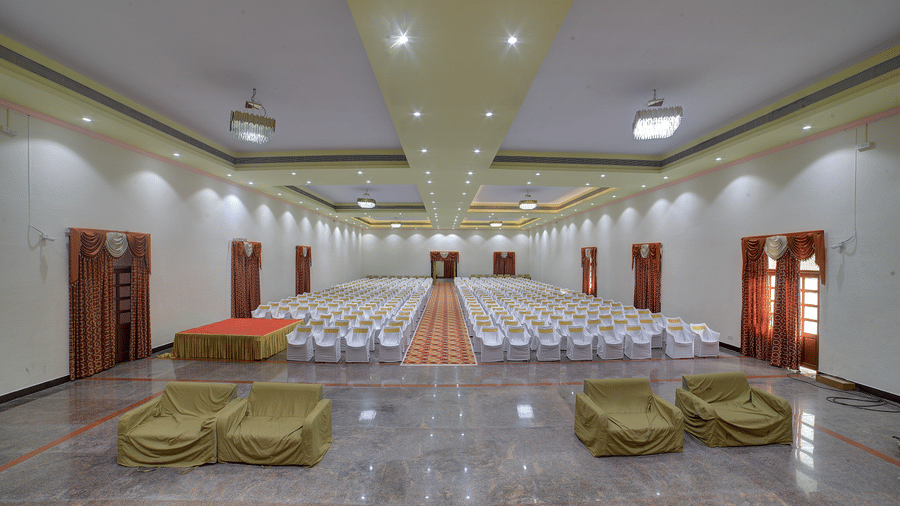 Spacious function hall with decorative seating and ample lighting at Kailash Conventions ECR.