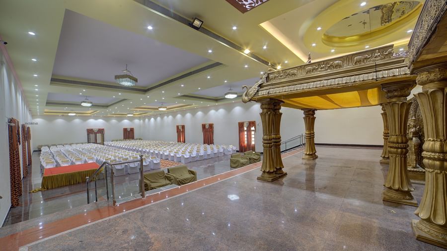 Grand indoor venue with stage backdrop and ornate pillars at Kailash Conventions ECR.