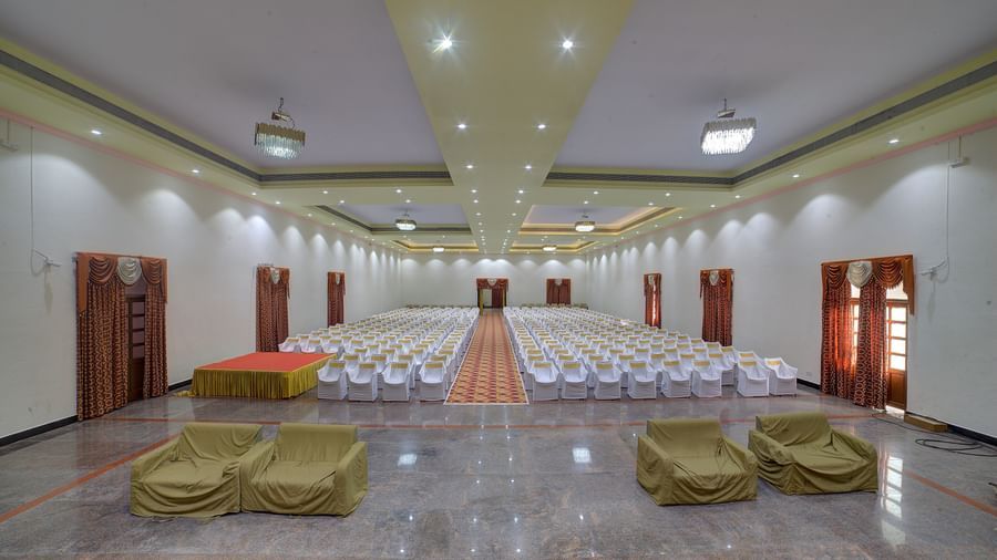 Spacious function hall with decorative seating and ample lighting at Kailash Conventions ECR.