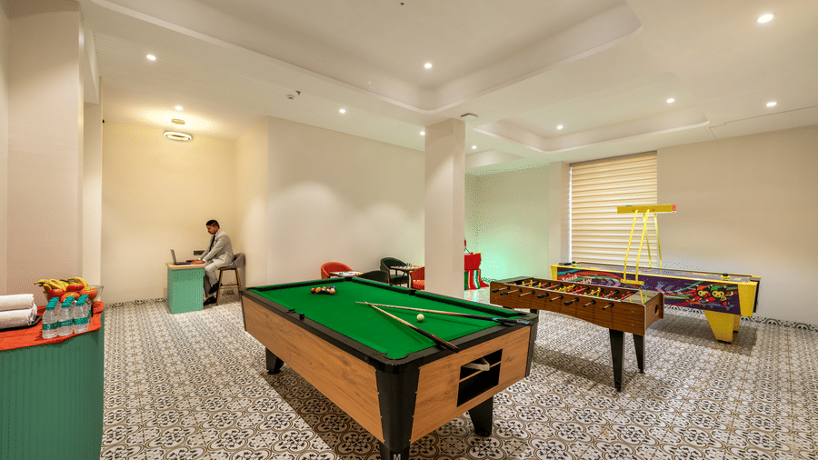 Games Room with a well-maintained pool table and foosball table at Lords Inn Somnath, offering a fun and engaging recreational space.