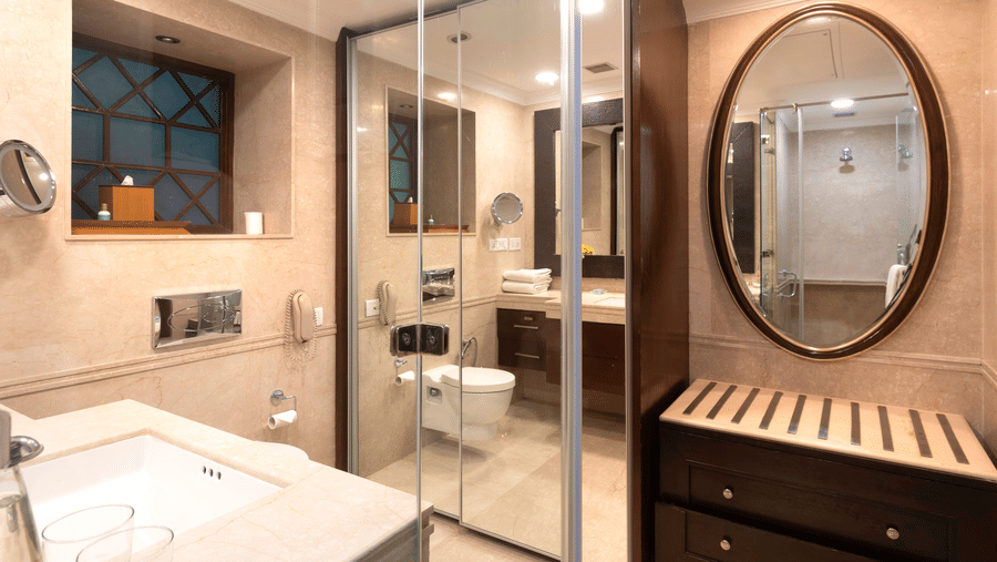 image of the bathroom with full legth mirror and an oval mirror at The Claridges Nabha Residence