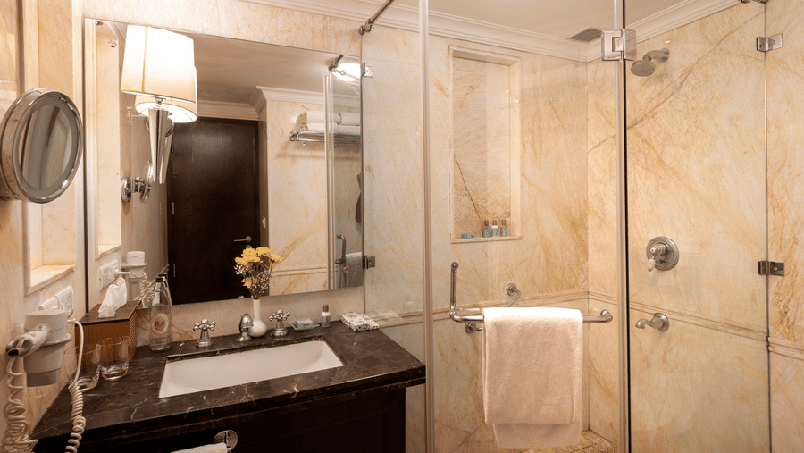 image of the bathroom with a sink and a cubical shower - The Claridges Nabha Residence