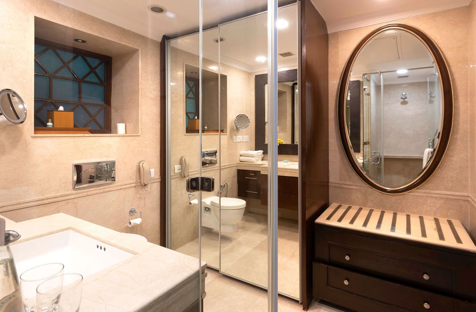 image of the bathroom with full legth mirror and an oval mirror at The Claridges Nabha Residence