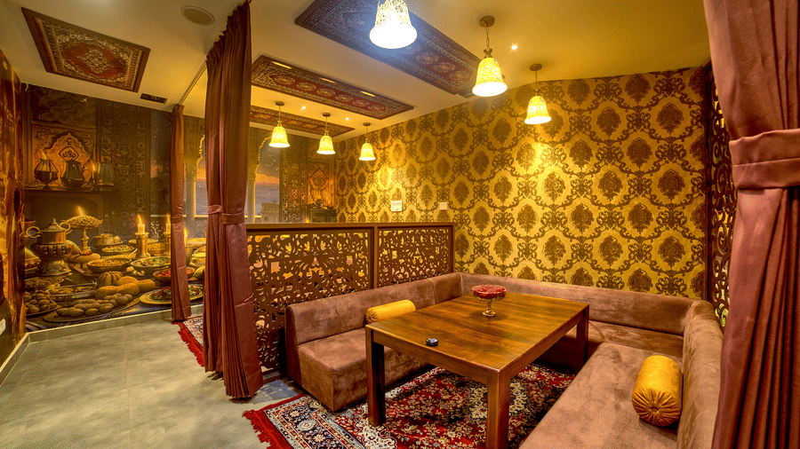 Cosy booth dining with regal interiors and rich curtains at Ilara Hotels & Spa, OMR, Chennai