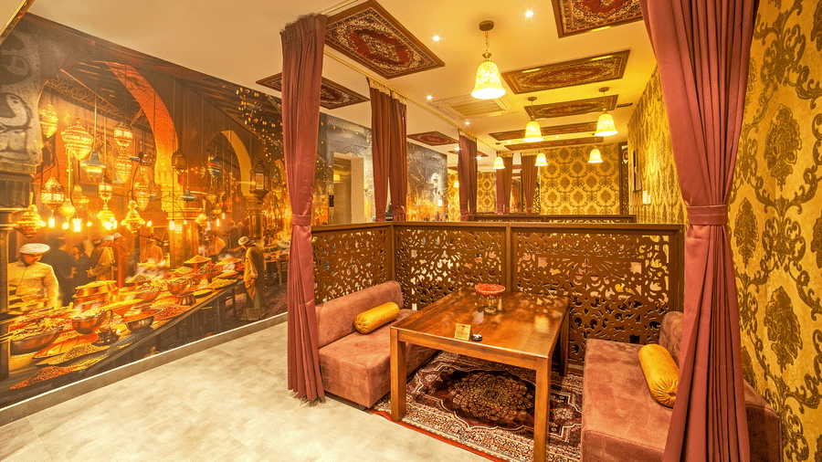 Elegant dining setup with traditional Indian mural at Ilara Hotels & Spa, OMR, Chennai