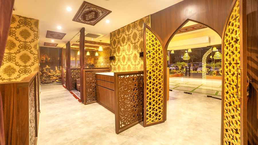 Decorative corridor with arches leading to intimate dining booths at Ilara Hotels & Spa, OMR, Chennai