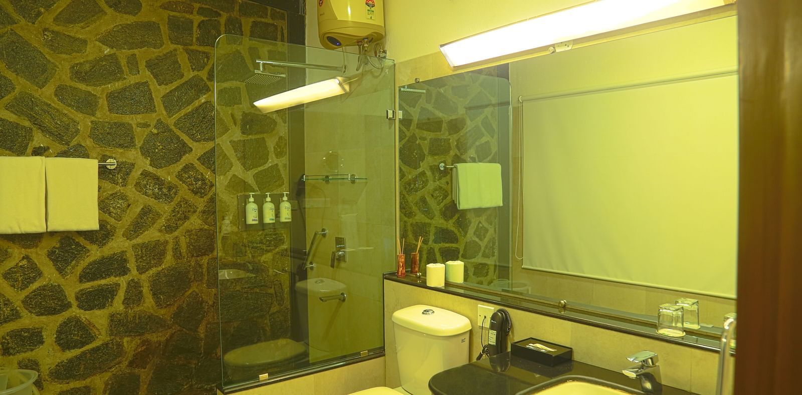 An image of a washroom with toiletries and bright lighting - Great Trails Yercaud by GRT Hotels - The Best Hotel in Yercaud