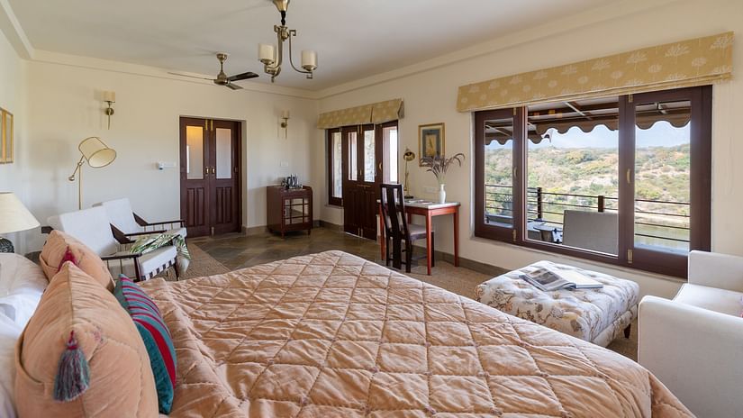 a king bed with a futon in front of it with sofas on the side inside a room - Chunda Shikar Oudi, Udaipur