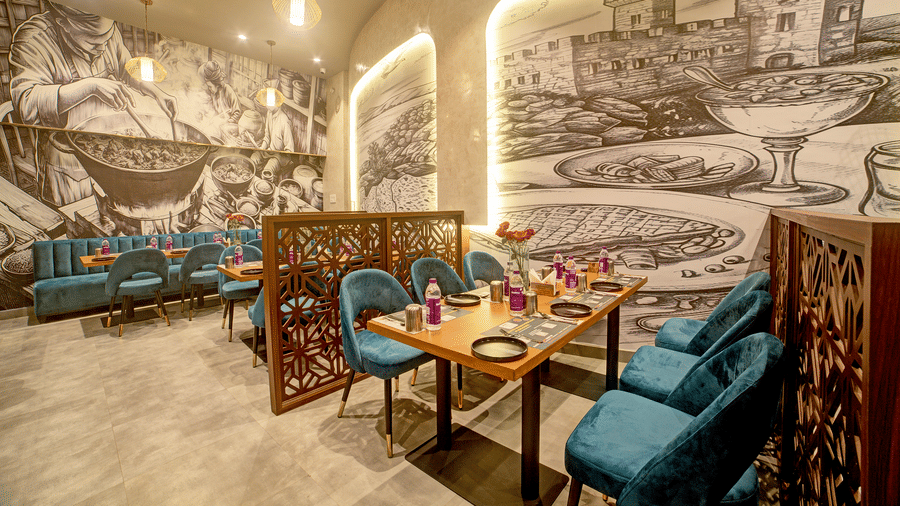 Artistic booth dining with illuminated mural and modern decor at Ilara Hotels & Spa, OMR, Chennai