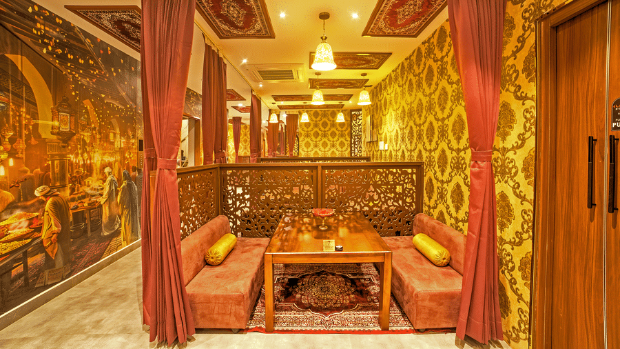 Royal-style booth with ethnic decor and mural artwork at Ilara Hotels & Spa, OMR, Chennai