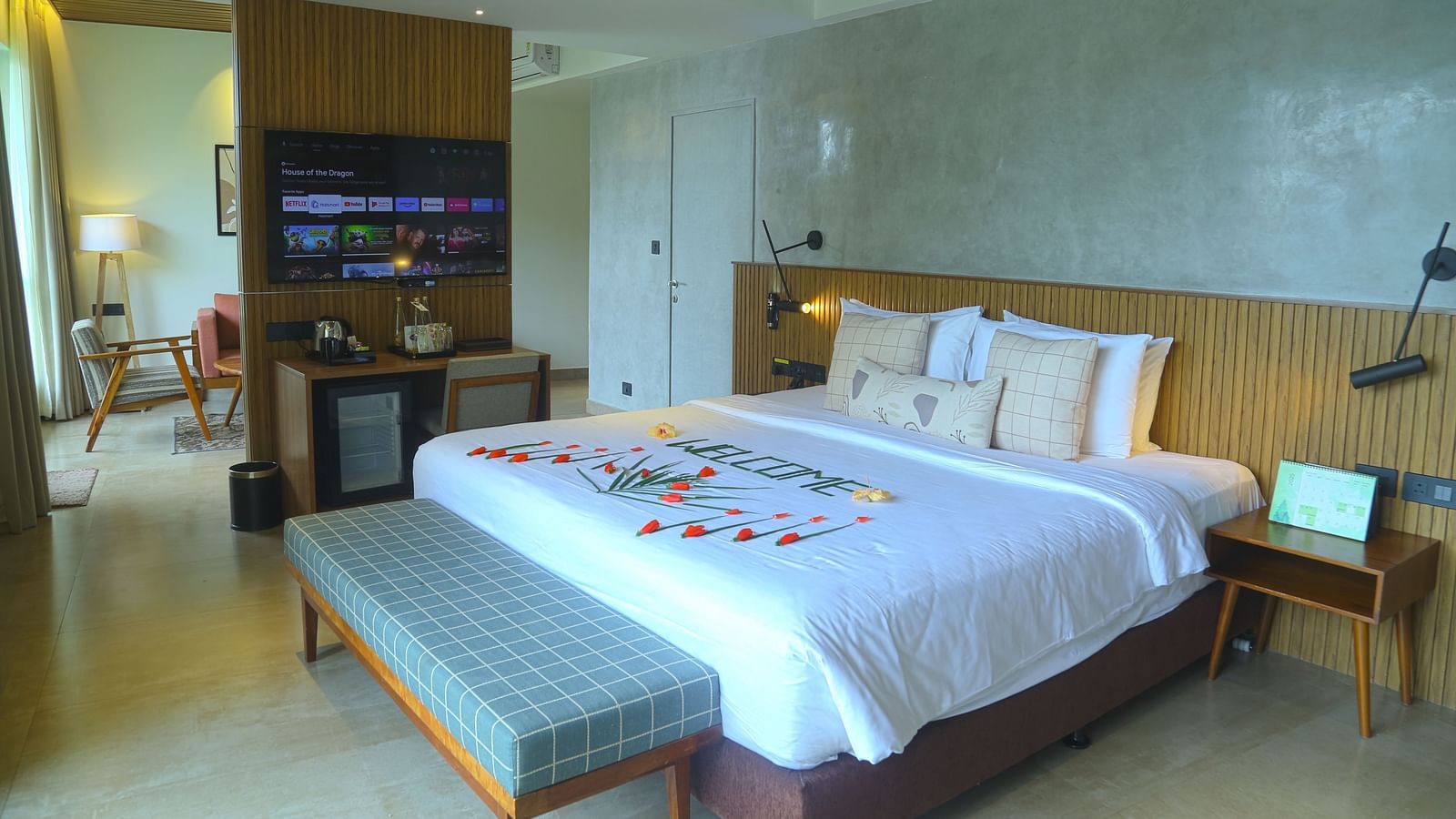 An image of the pent house room with a king size bed, couch, bed side table, and flat screen TV - Great Trails Yercaud by GRT Hotels