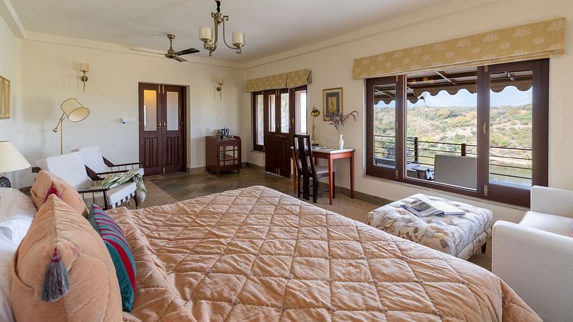 a king bed with a futon in front of it with sofas on the side inside a room - Chunda Shikar Oudi, Udaipur