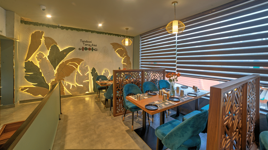 Bright dining space with contemporary design and green accents at Ilara Hotels & Spa, OMR, Chennai