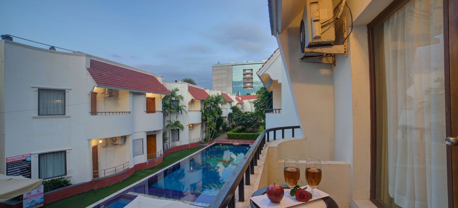 Balcony view of the property and poolside seating area at Ilara Hotels & Spa, OMR, Chennai