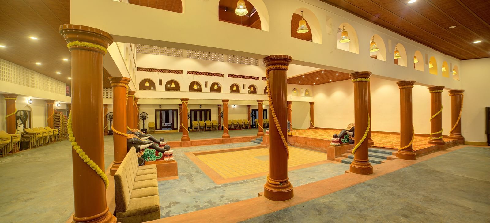Traditional entrance with pillars and archways illuminated by warm lighting at Kailash Conventions ECR.