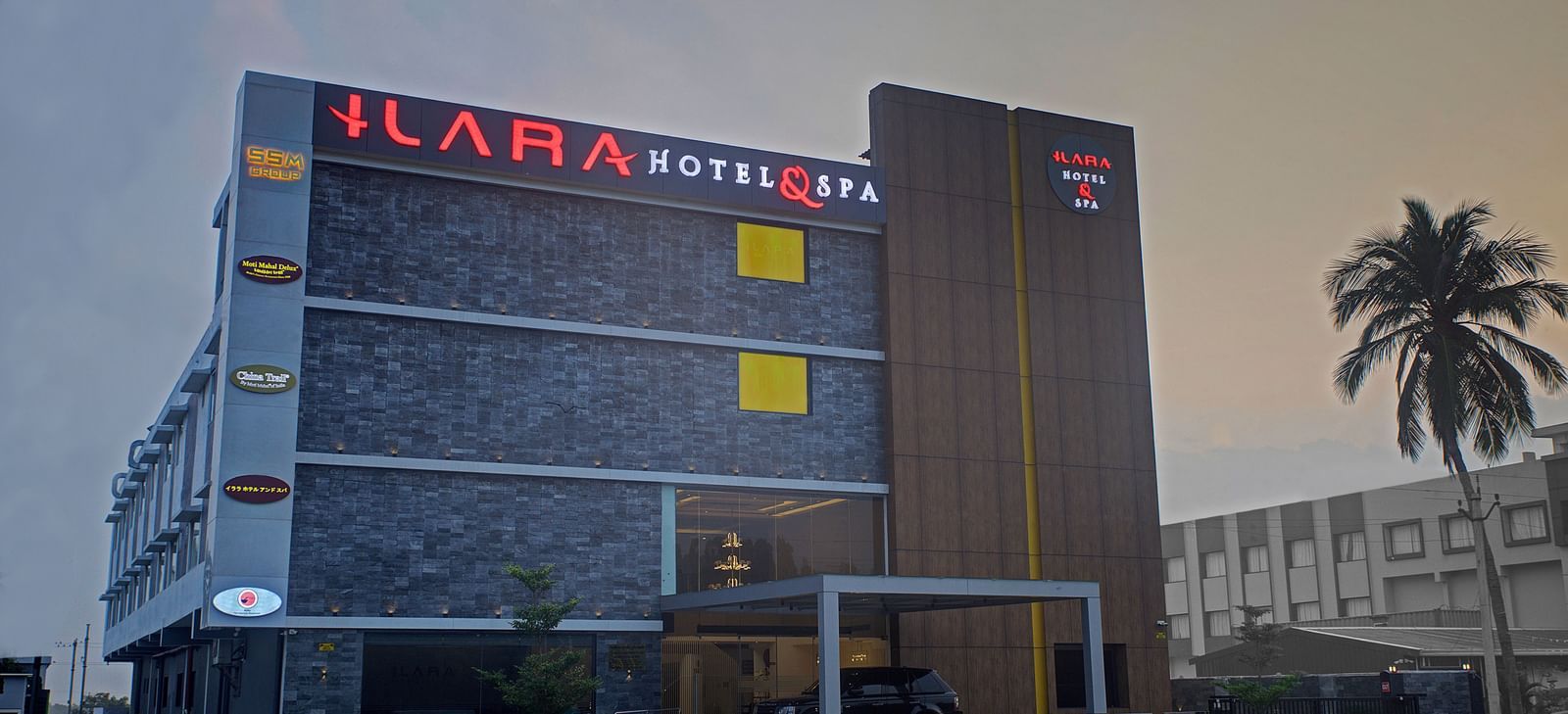 Facade of Ilara Hotels & Spa, Tada with a drive way in the foreground during the late evening hours.