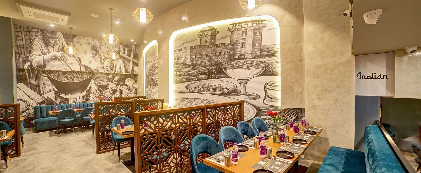 Elegant dining booths with monochrome wall art at Ilara Hotels & Spa, OMR, Chennai