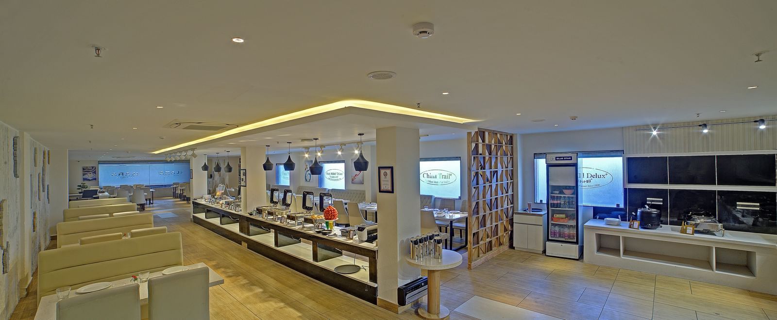 A wide angle shot of the restaurant with the buffet counter between two pillars at Ilara Hotels & Spa, Tada.