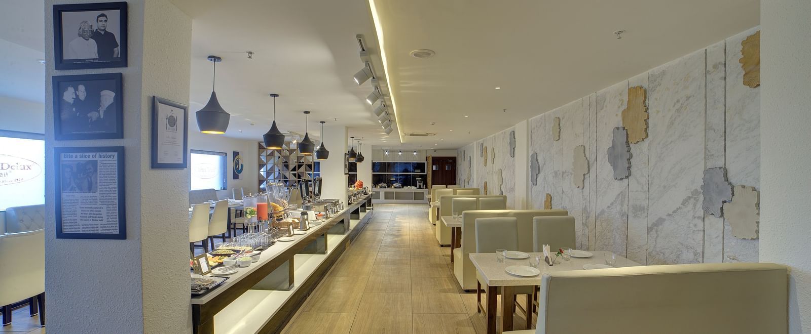 A pathway between the buffet counter and the dining tables at the Moti Mahal restaurant at Ilara Hotels & Spa, Tada.