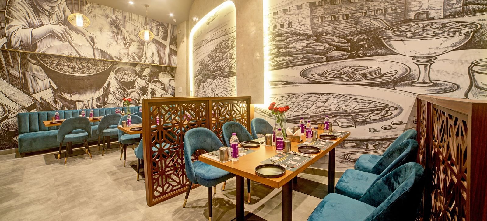 Artistic booth dining with illuminated mural and modern decor at Ilara Hotels & Spa, OMR, Chennai