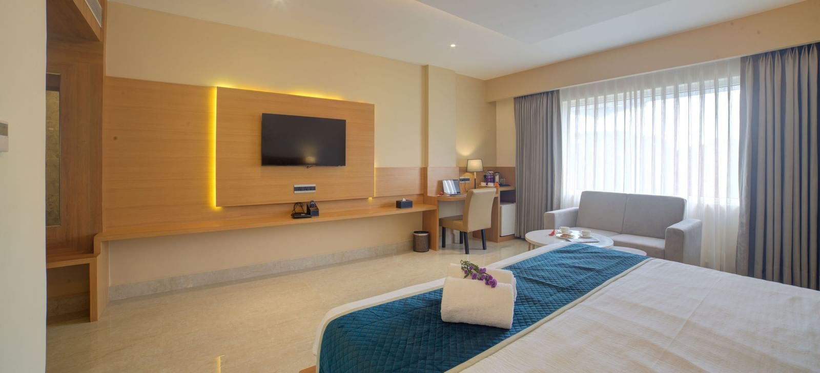 Ample of natural light coming into the Junior Suite from the windows covered by thin linen curtains at Ilara Hotels & Spa, Tada.