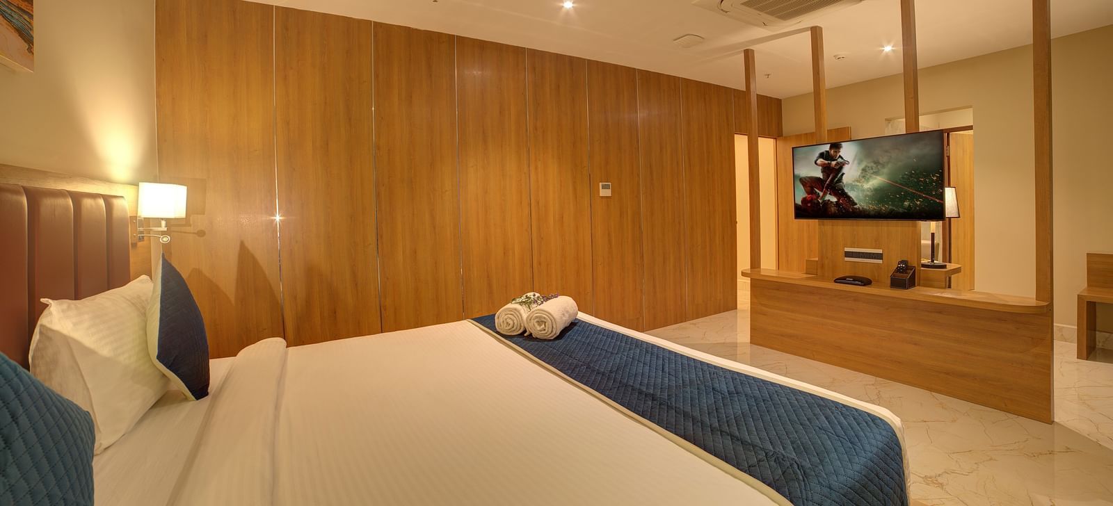 Corner view shot of the bedroom of the Executive Suite featuring a double bed overlooking a wall mounted television at Ilara Hotels & Spa, Tada.