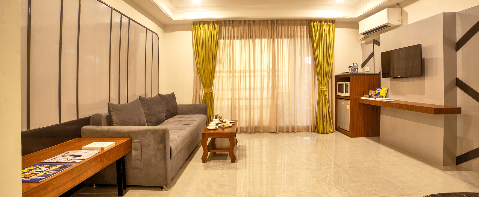 Spacious suite with large sectional sofa and extended seating area at Ilara Hotels & Spa, OMR, Chennai