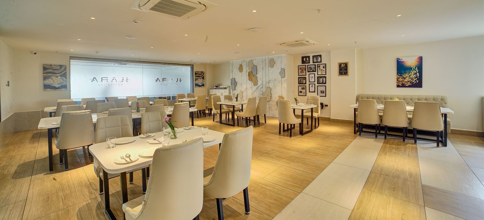 Back view of the Moti Mahal Restaurant with neatly arranged chairs and dining tables at Ilara Hotels & Spa, Tada.