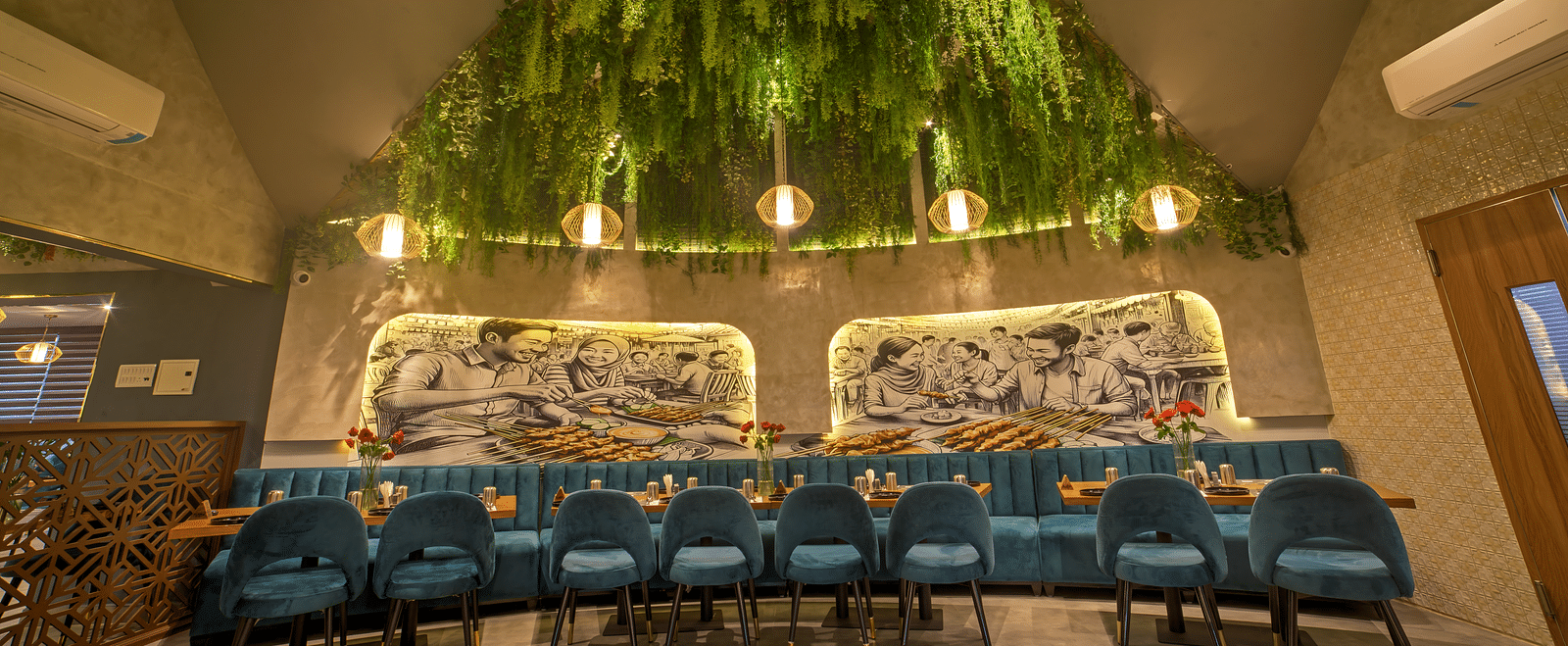 Stylish ceiling with hanging greenery above long dining table at Ilara Hotels & Spa, OMR, Chennai