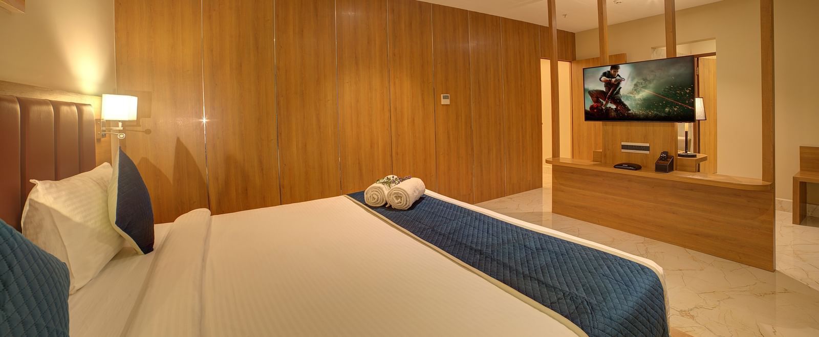 Corner view shot of the bedroom of the Executive Suite featuring a double bed overlooking a wall mounted television at Ilara Hotels & Spa, Tada.