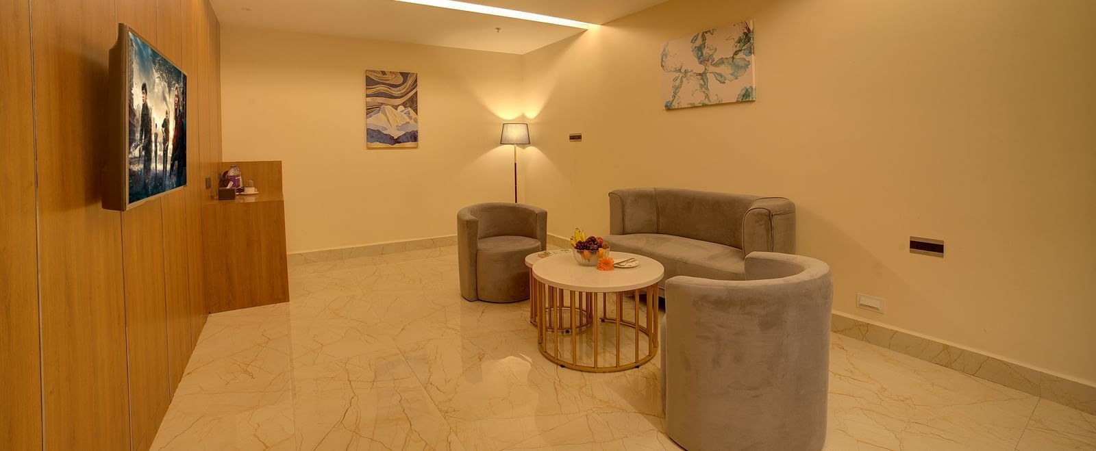 Full view shot of the separate living area with a chic couch set along with a coffee table in front of it at Ilara Hotels & Spa, Tada.