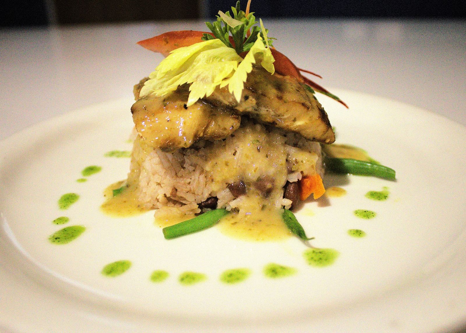 Layered gourmet dish with fresh greens and artistic sauce drizzle - Hotel 39, Jamaica