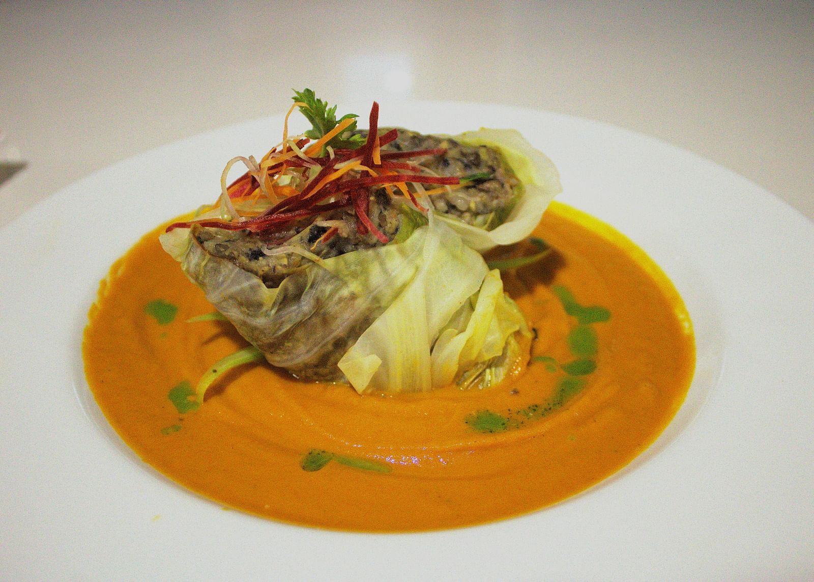 Delicately plated seafood in an orange sauce with fresh garnishes - Hotel 39, Jamaica