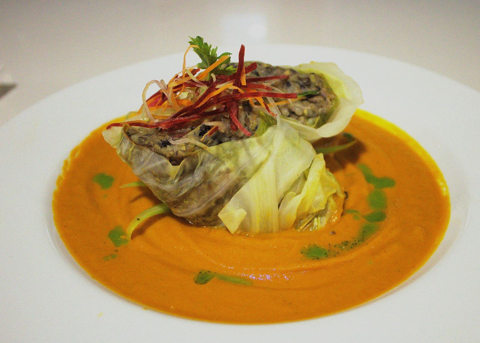 Delicately plated seafood in an orange sauce with fresh garnishes - Hotel 39, Jamaica