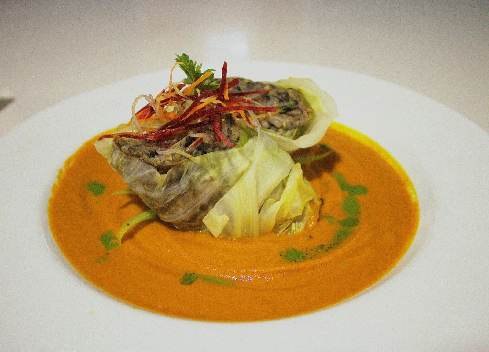 Delicately plated seafood in an orange sauce with fresh garnishes - Hotel 39, Jamaica