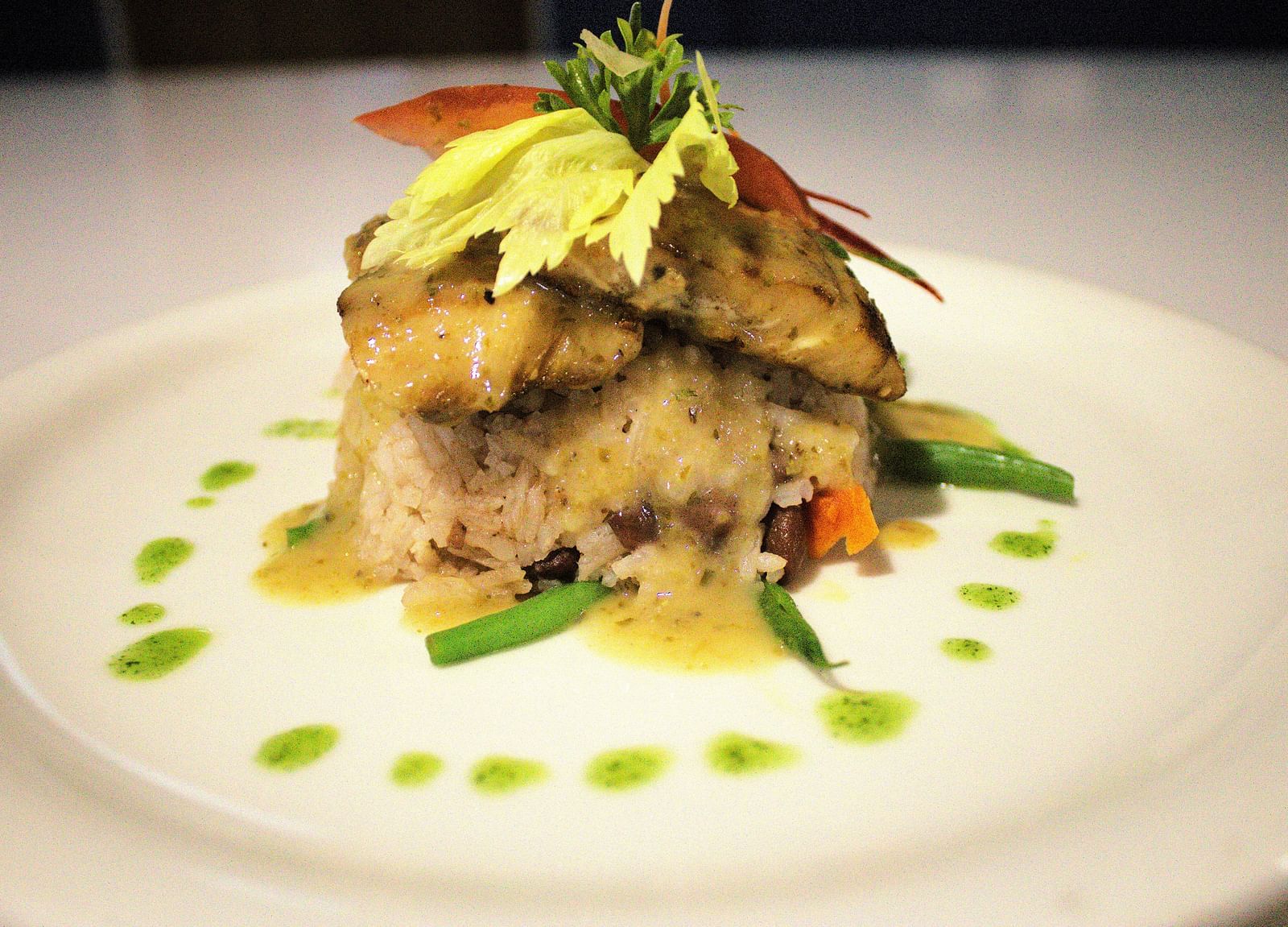 Layered gourmet dish with fresh greens and artistic sauce drizzle - Hotel 39, Jamaica