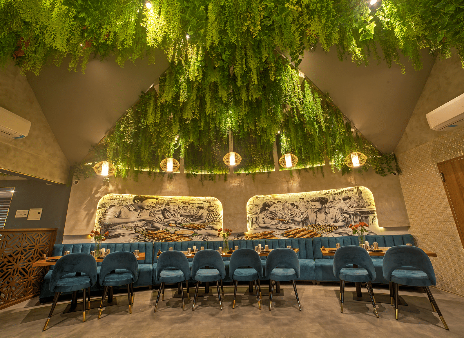 Stylish ceiling with hanging greenery above long dining table at Ilara Hotels & Spa, OMR, Chennai