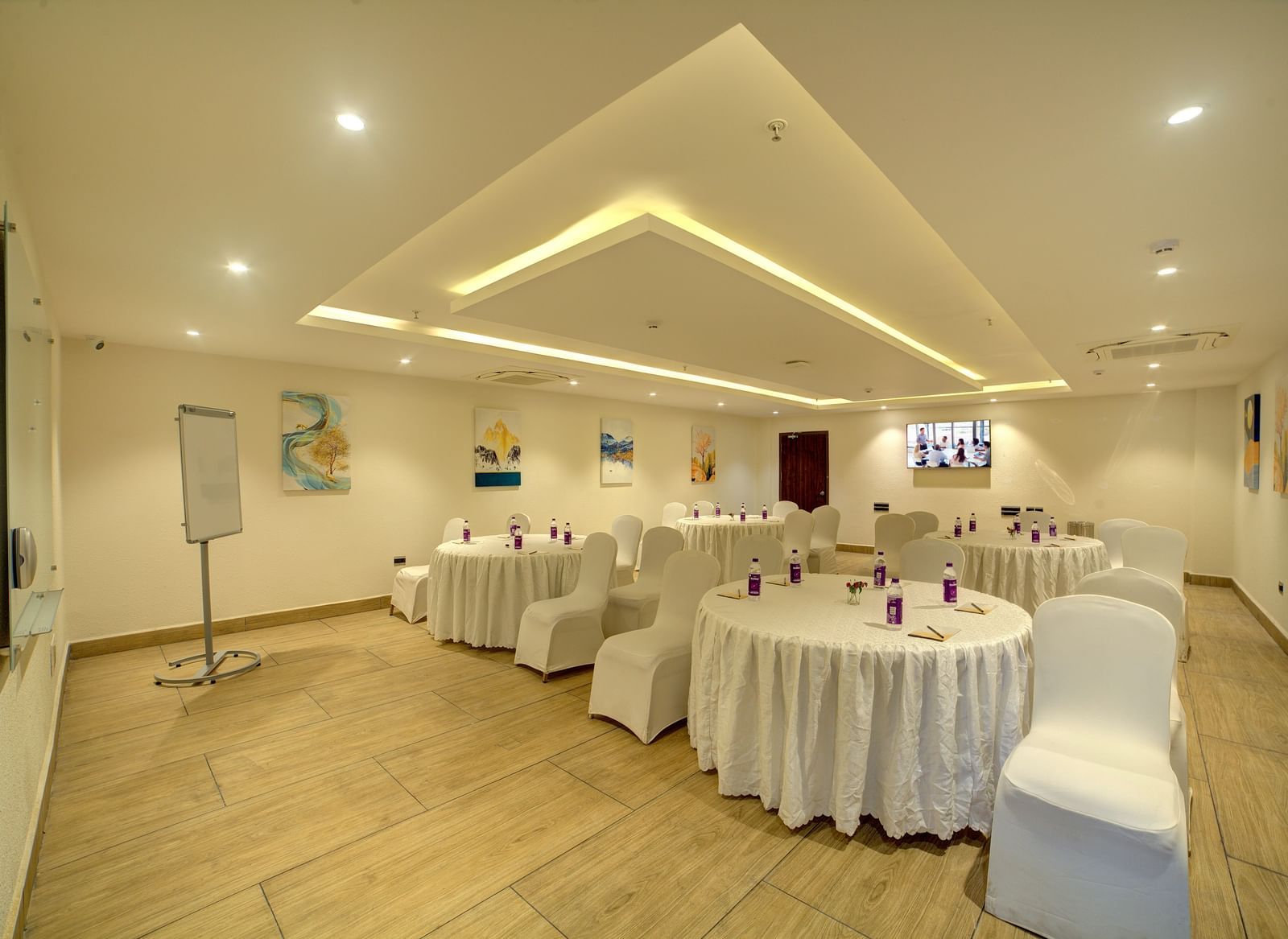 Corner view of the banquet hall with all the chairs facing towards the empty area in the foreground at Ilara Hotels & Spa, Tada.
