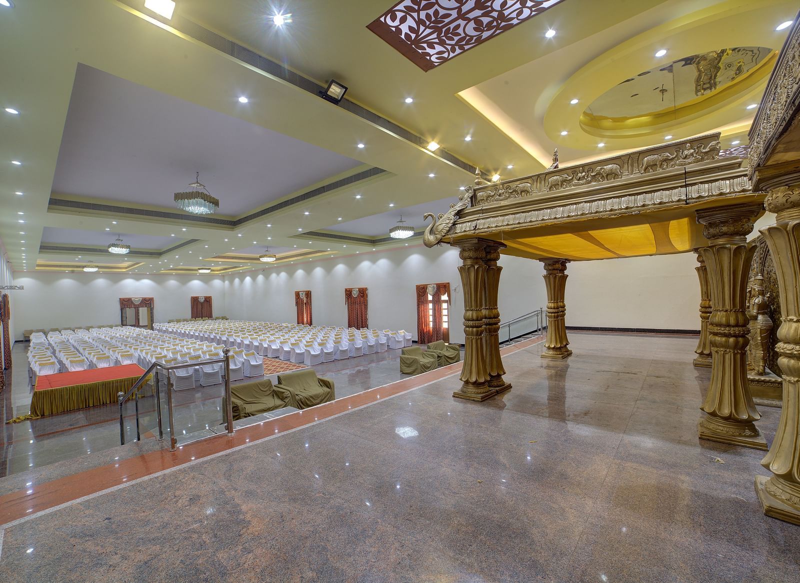 Grand indoor venue with stage backdrop and ornate pillars at Kailash Conventions ECR.