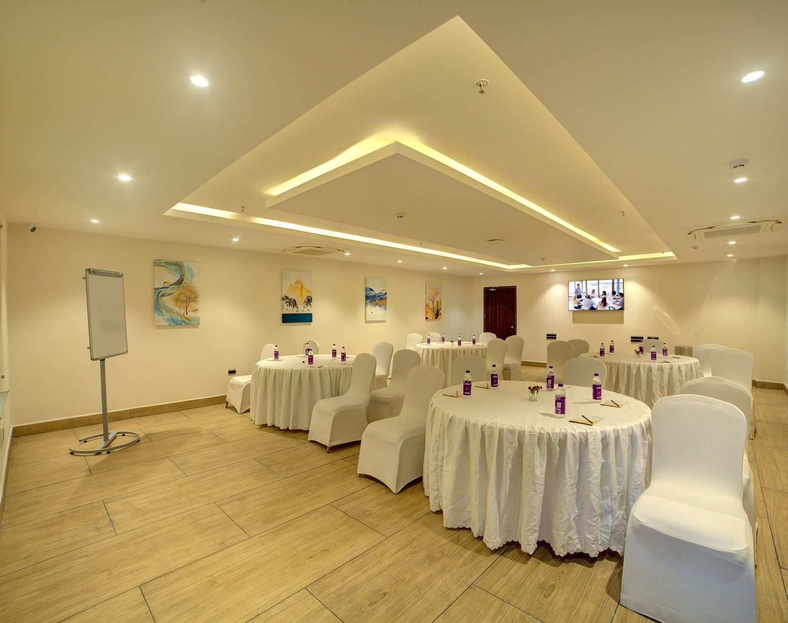 Corner view of the banquet hall with all the chairs facing towards the empty area in the foreground at Ilara Hotels & Spa, Tada.