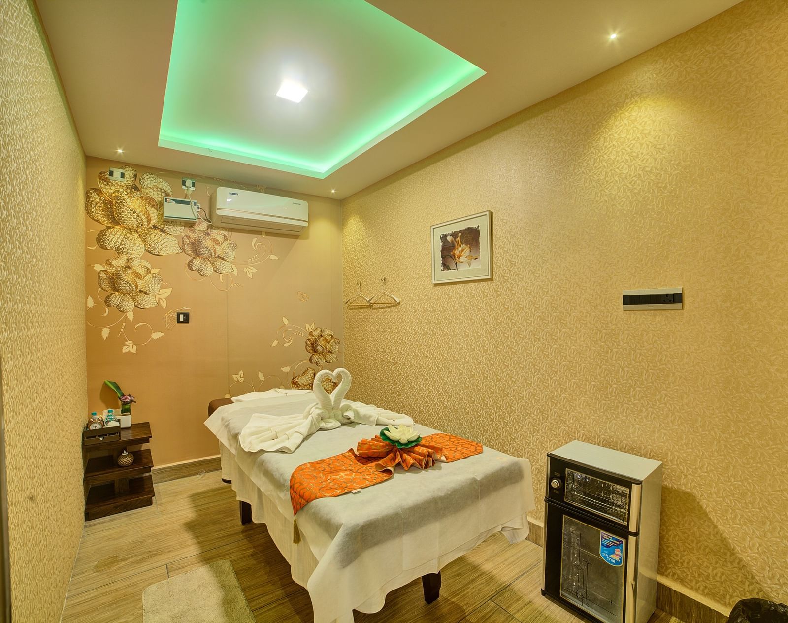 A cosy spa or treatment room featuring a massage bed, calming lighting, and decorative elements at Ilara Hotels & Spa.
