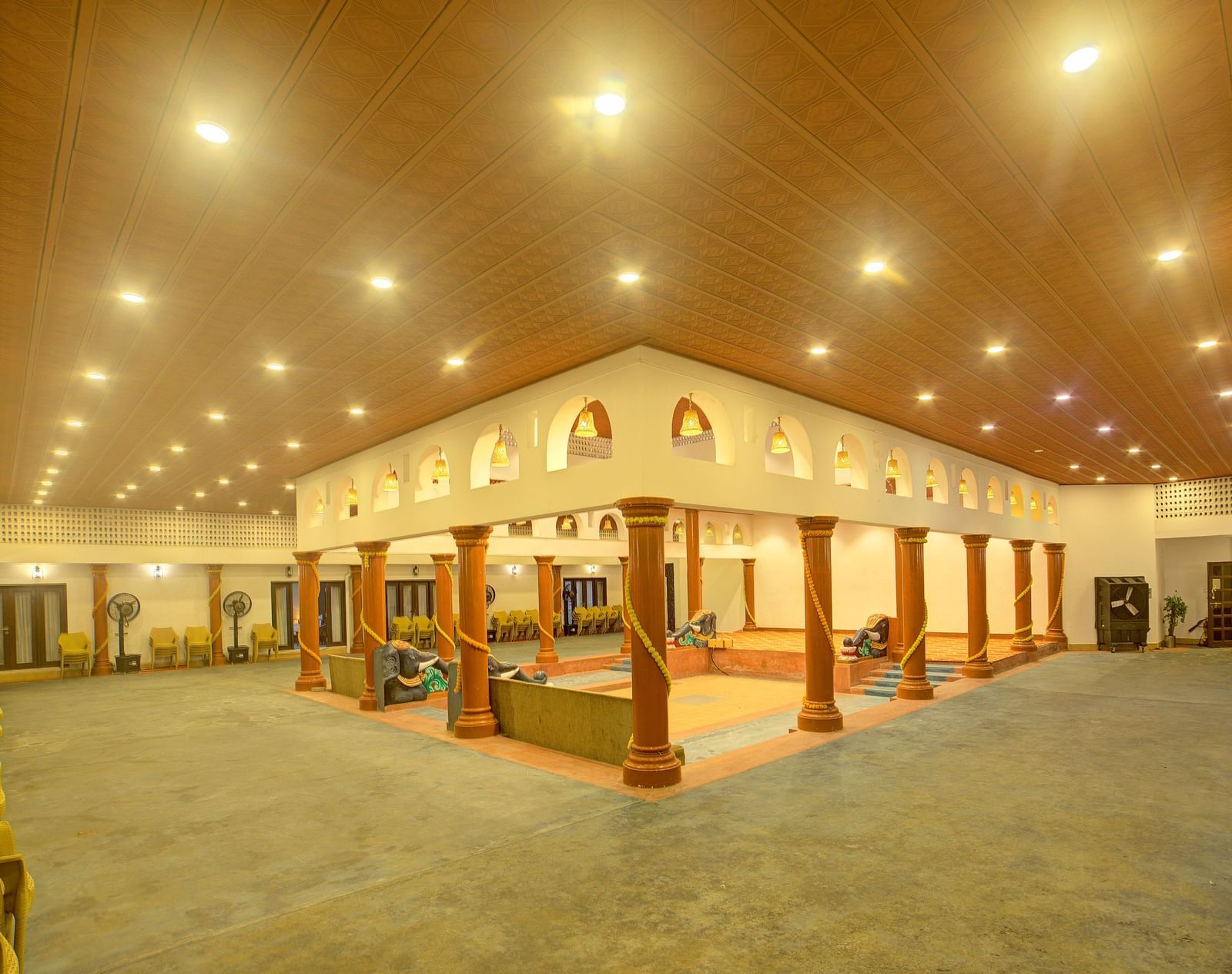 A wide hall or event space with high ceilings, bright lighting, and decorative wall panels at Ilara Hotels & Spa.