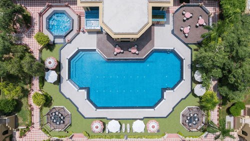 an aerial view of the swimming pool with garden surrounding it - Heritage Village Resorts & Spa, Manesar.