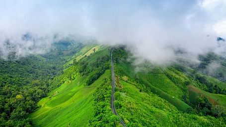 Aerial view of the green hills and misty landscapes of Wayanad Wildlife Sanctuary.