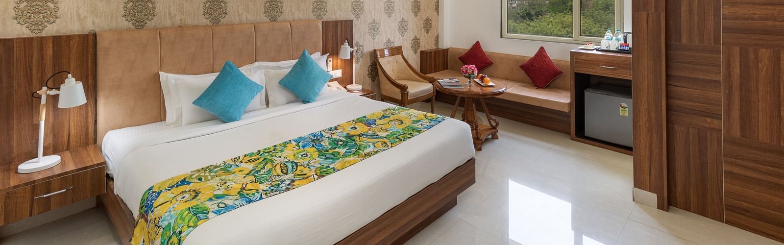 A spacious hotel room featuring a king size bed, comfortable seating, and modern amenities | Inde Hotel Cyber City 